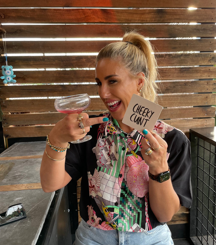 A cheeky cunt proudly posing with a cheeky cunt coaster